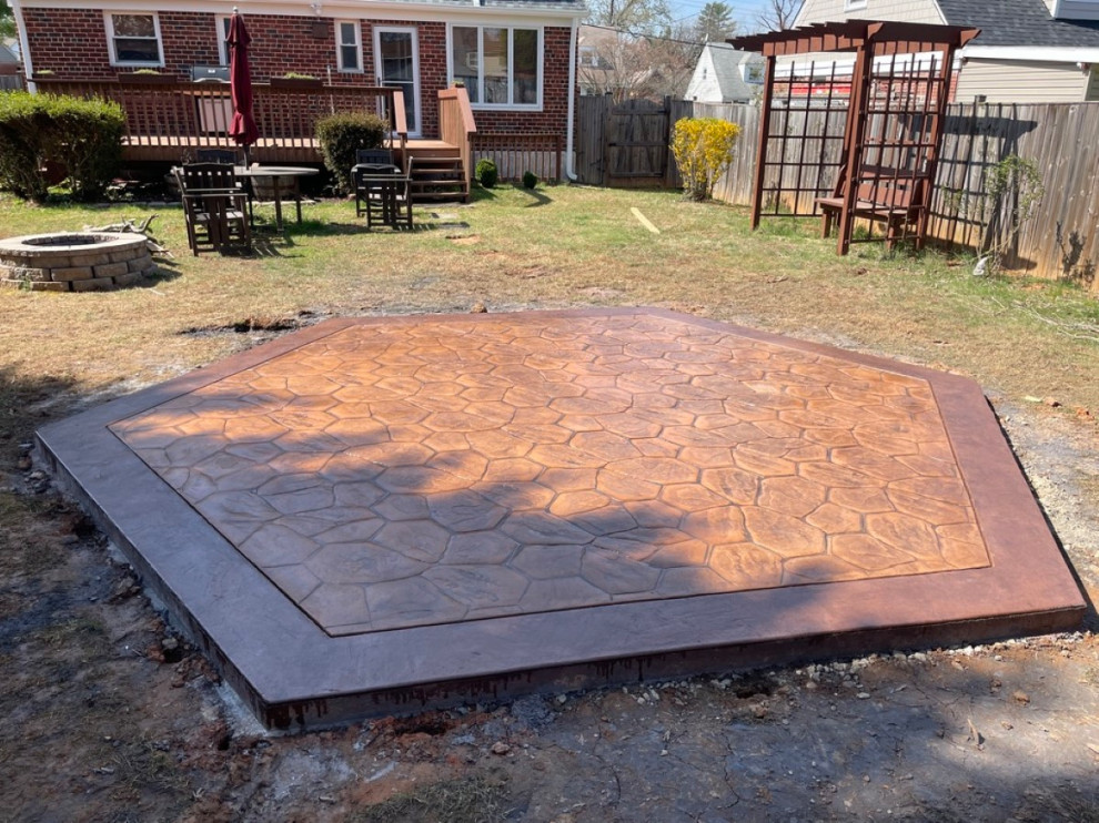 Photo of a traditional back patio in DC Metro with stamped concrete.