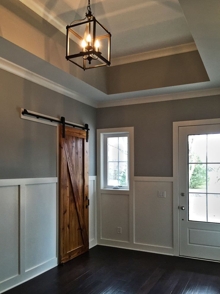 Large country foyer in Columbus with grey walls, dark hardwood floors, a single front door and a white front door.