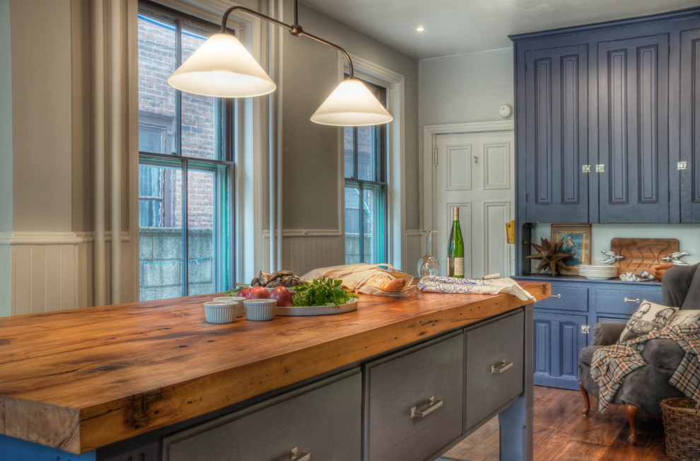 Inspiration for a traditional kitchen in Philadelphia with wood benchtops, raised-panel cabinets and blue cabinets.