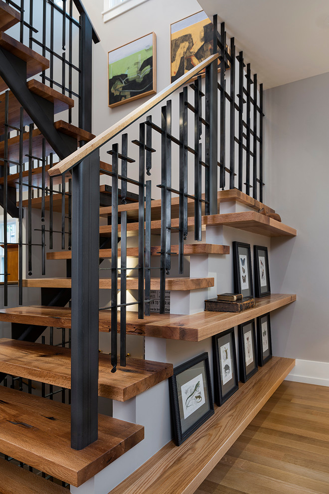 Photo of a mid-sized arts and crafts wood u-shaped staircase in Detroit with open risers and metal railing.