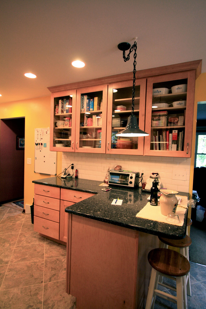 Inspiration for a small transitional eat-in kitchen remodel with an undermount sink, recessed-panel cabinets, light wood cabinets, quartz countertops, white backsplash, subway tile backsplash, white appliances and a peninsula