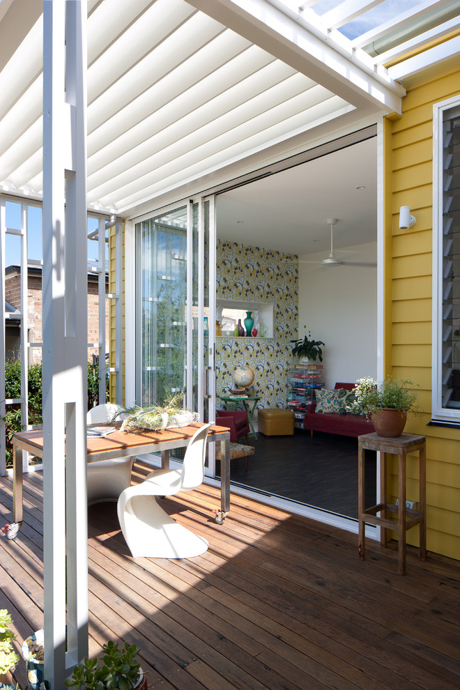 Photo of a small eclectic backyard deck in Sydney with a pergola.