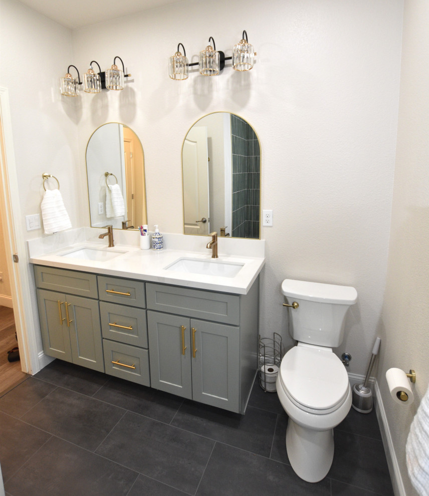 Example of a mid-sized transitional green tile and porcelain tile vinyl floor, gray floor and double-sink alcove bathtub design with shaker cabinets, green cabinets, an undermount sink, solid surface countertops, white countertops and a built-in vanity