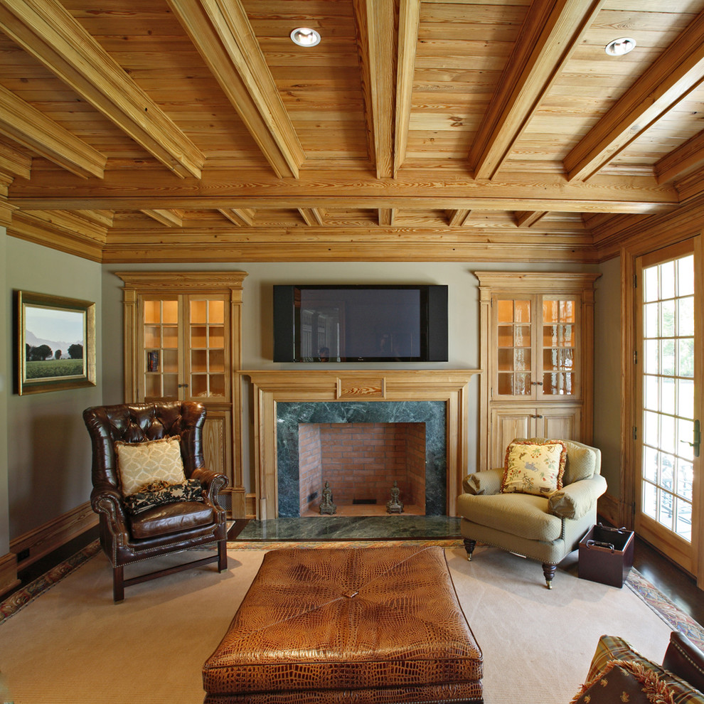 Inspiration for a traditional enclosed family room in New York with green walls, dark hardwood floors, a standard fireplace, a wood fireplace surround and a wall-mounted tv.