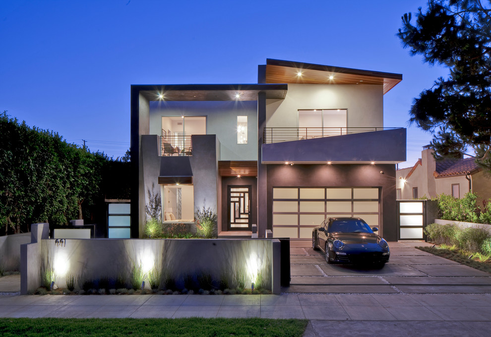 Inspiration for a large contemporary two-storey stucco beige exterior in Los Angeles with a flat roof.