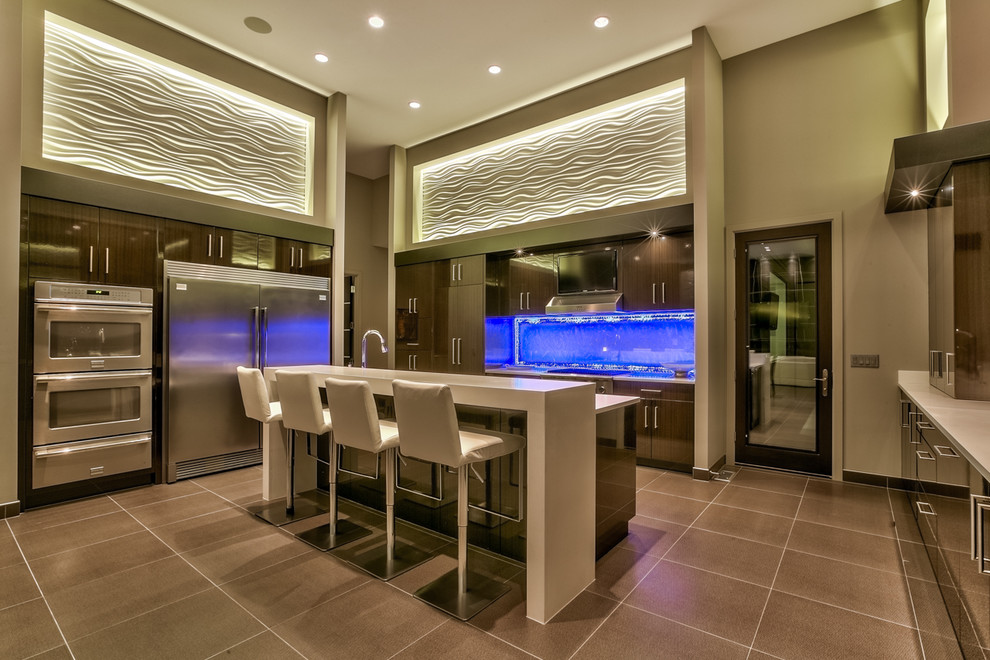 Design ideas for an expansive contemporary u-shaped separate kitchen in Omaha with flat-panel cabinets, dark wood cabinets, quartzite benchtops, white splashback, stone slab splashback, stainless steel appliances, with island, an undermount sink and brown floor.