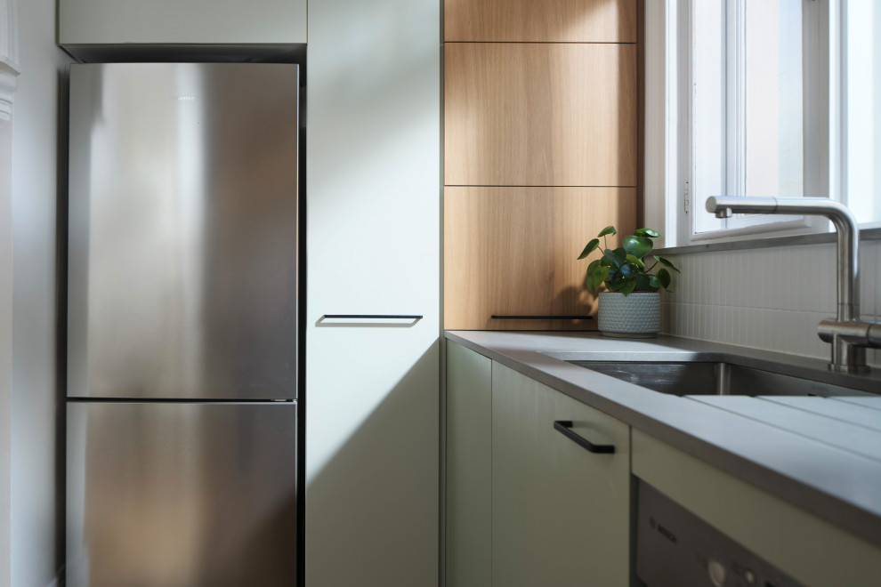 Medium sized modern u-shaped kitchen/diner in Sydney with a submerged sink, flat-panel cabinets, green cabinets, recycled glass countertops, white splashback, matchstick tiled splashback, stainless steel appliances, no island and grey worktops.