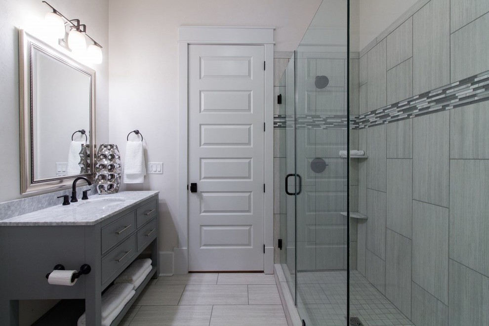 This is an example of a small transitional 3/4 bathroom in Atlanta with flat-panel cabinets, grey cabinets, a corner shower, porcelain tile, white walls, ceramic floors, a drop-in sink and marble benchtops.