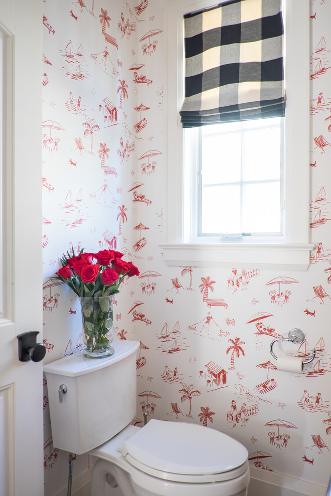 Design ideas for a beach style powder room in Toronto with a two-piece toilet and red walls.