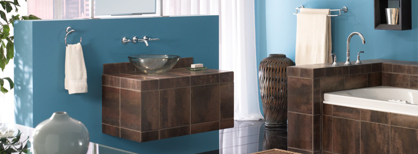 Design ideas for a mid-sized modern master bathroom in Other with an alcove tub, brown tile, porcelain tile, blue walls, a vessel sink, tile benchtops and brown benchtops.