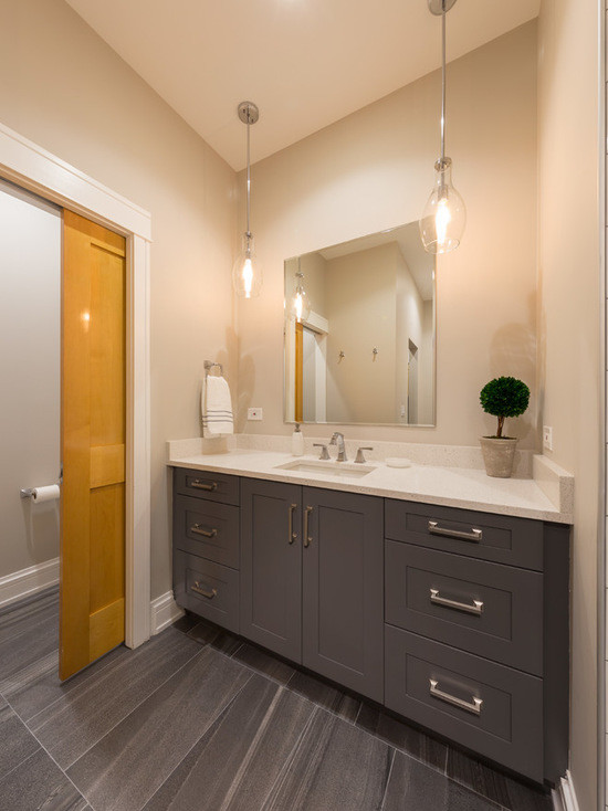 Mid-sized contemporary master bathroom in Chicago with recessed-panel cabinets, dark wood cabinets, an alcove shower, white tile, mosaic tile, beige walls, mosaic tile floors, an undermount sink and limestone benchtops.