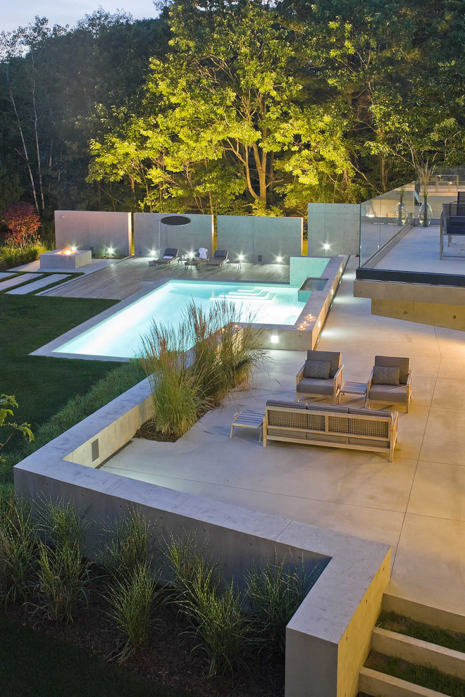 This is an example of a contemporary pool in Burlington with decking.