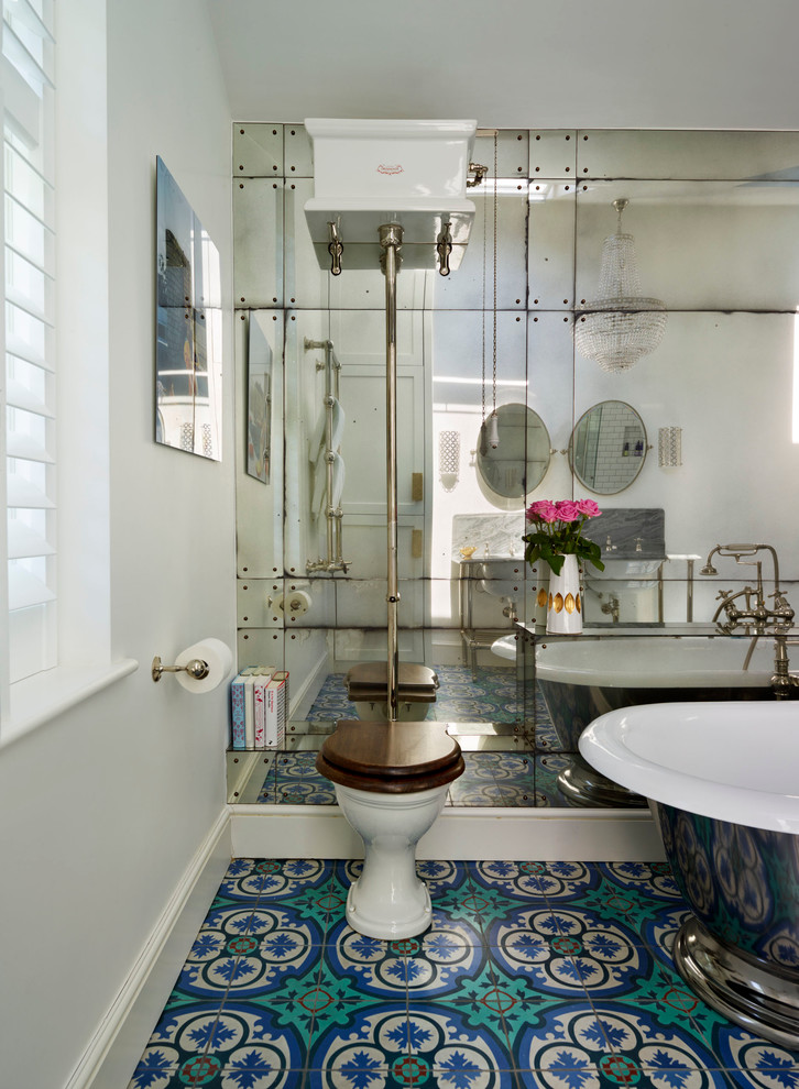 This is an example of a traditional master bathroom in London with granite benchtops, blue tile and cement tile.