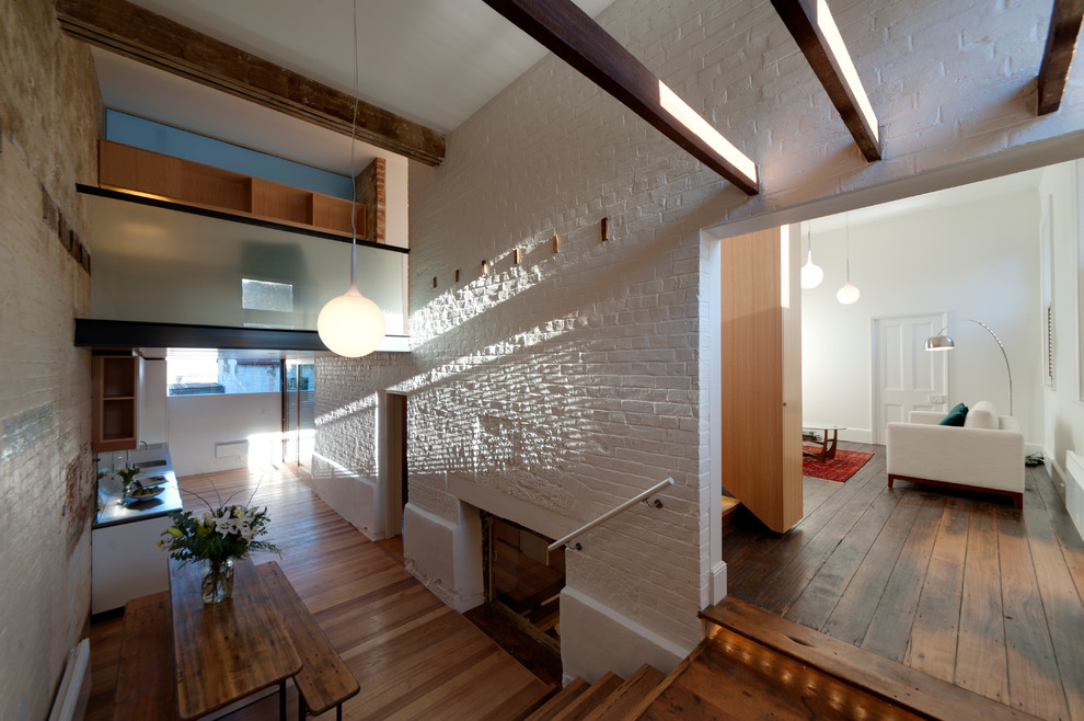 Photo of a large contemporary open plan dining in Hobart with white walls, medium hardwood floors and no fireplace.