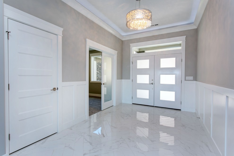 Mid-sized transitional marble floor and white floor foyer photo in Seattle with gray walls and a white front door