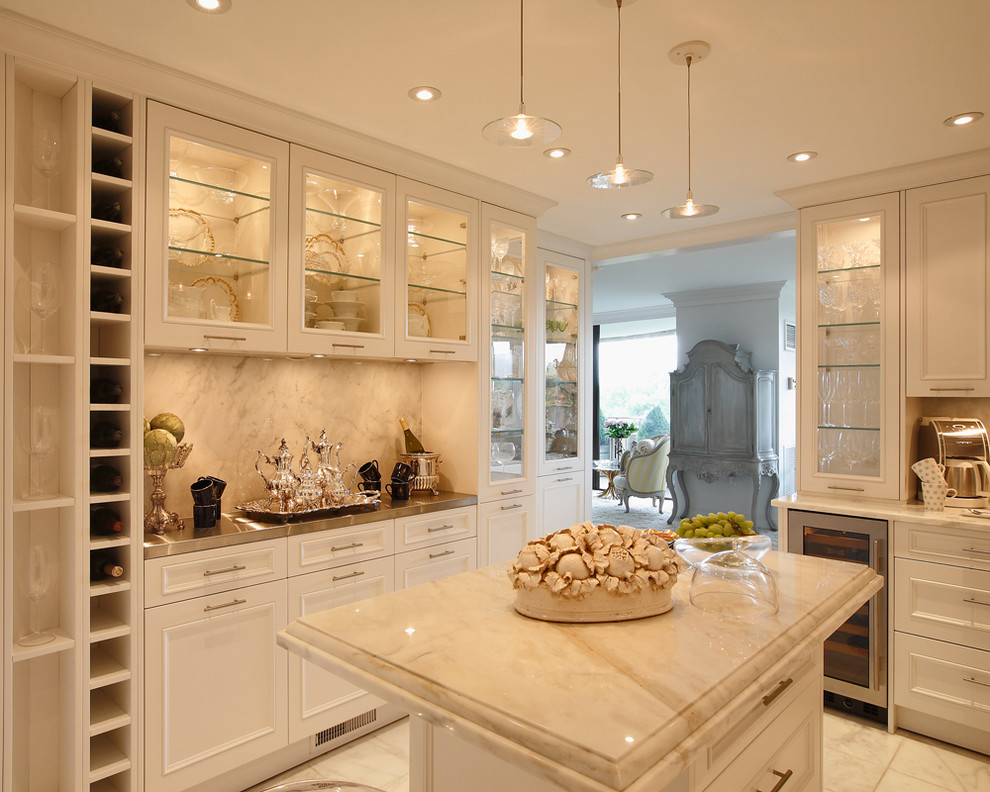This is an example of a mid-sized traditional u-shaped separate kitchen in DC Metro with an undermount sink, white cabinets, marble benchtops, white splashback, stainless steel appliances, marble floors and with island.