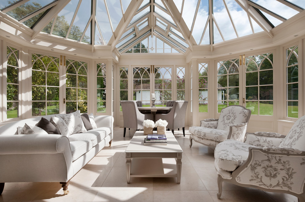 Large traditional sunroom in Surrey with travertine floors, a glass ceiling and beige floor.