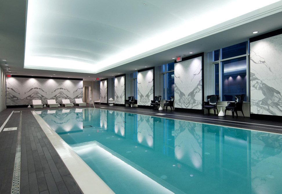 Pool - huge modern rectangular pool idea in Toronto with decking