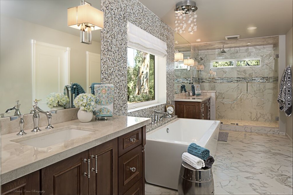 Photo of a large transitional master bathroom in Phoenix with shaker cabinets, medium wood cabinets, a freestanding tub, an open shower, a one-piece toilet, white tile, ceramic tile, white walls, ceramic floors, an undermount sink and quartzite benchtops.