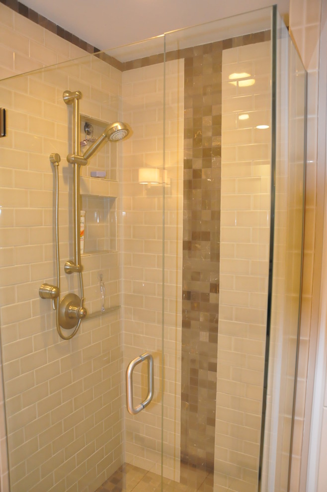Small transitional 3/4 beige tile and ceramic tile porcelain tile corner shower photo in Seattle with an undermount sink, recessed-panel cabinets, white cabinets, quartzite countertops, a two-piece toilet and brown walls
