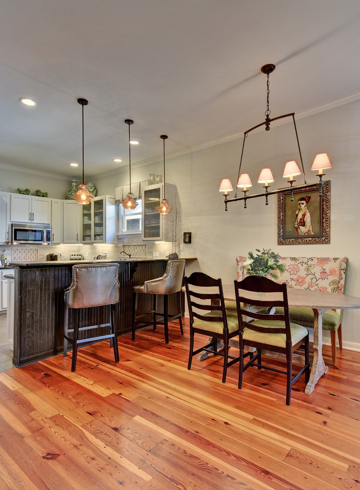 Photo of a small transitional open plan dining in Austin with green walls and medium hardwood floors.