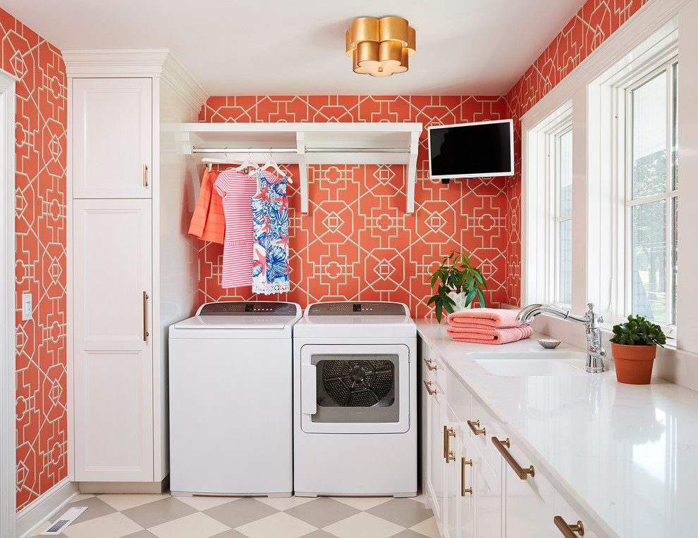 Traditional dedicated laundry room in Minneapolis with an undermount sink, recessed-panel cabinets, white cabinets, a side-by-side washer and dryer, multi-coloured floor, white benchtop and red walls.