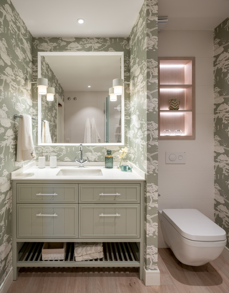 Mid-sized transitional 3/4 bathroom in Other with raised-panel cabinets, white cabinets, a curbless shower, white tile, green walls, laminate floors, an undermount sink, engineered quartz benchtops, brown floor, white benchtops, a double vanity, a built-in vanity and wallpaper.