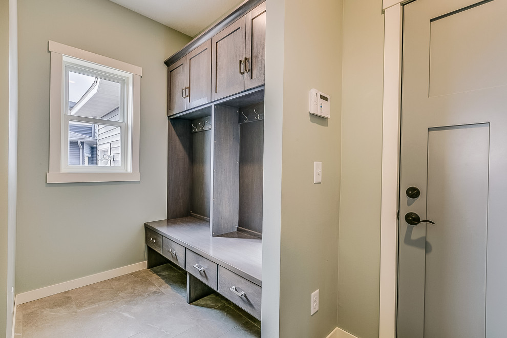 Inspiration for a mid-sized traditional mudroom in Minneapolis with grey walls, vinyl floors, a gray front door and grey floor.