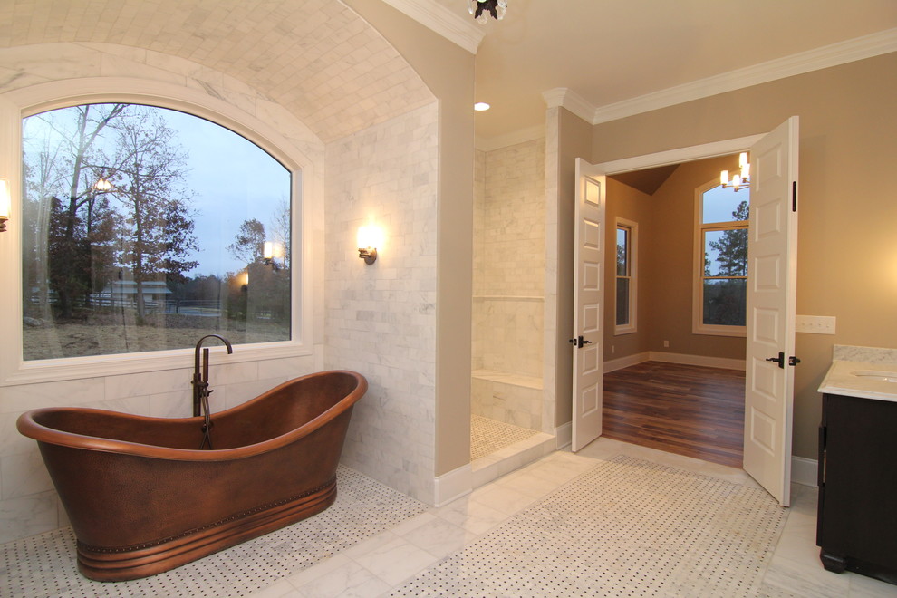 This is an example of an expansive arts and crafts master bathroom in Raleigh with an undermount sink, furniture-like cabinets, dark wood cabinets, granite benchtops, a freestanding tub, an open shower, a one-piece toilet, white tile, ceramic tile, grey walls and ceramic floors.