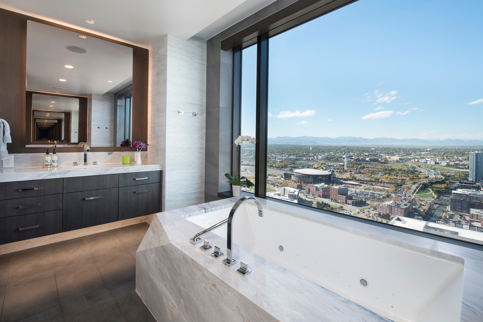 Design ideas for a large contemporary master bathroom in Denver with flat-panel cabinets, dark wood cabinets, an undermount tub, a corner shower, a one-piece toilet, white tile, marble, white walls, limestone floors, an undermount sink, quartzite benchtops, grey floor, a hinged shower door and white benchtops.