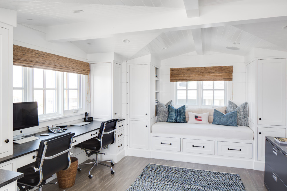 This is an example of a beach style study room in Orange County with white walls and a built-in desk.