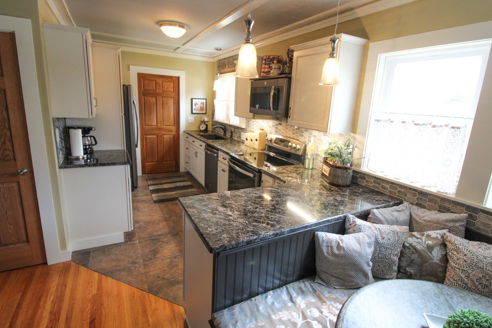 Inspiration for a transitional multicolored floor kitchen remodel with an undermount sink, recessed-panel cabinets, white cabinets, granite countertops, multicolored backsplash, mosaic tile backsplash, stainless steel appliances and black countertops