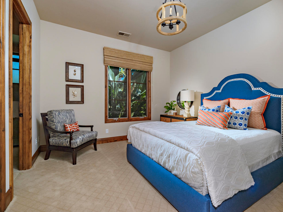 Design ideas for a mid-sized mediterranean guest bedroom in San Diego with beige walls, carpet and beige floor.