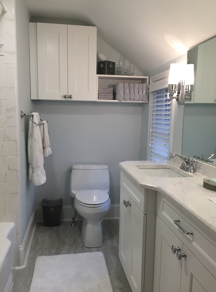Design ideas for a small transitional bathroom in Philadelphia with an undermount sink, shaker cabinets, white cabinets, engineered quartz benchtops, an alcove tub, a one-piece toilet, gray tile, stone tile and grey walls.