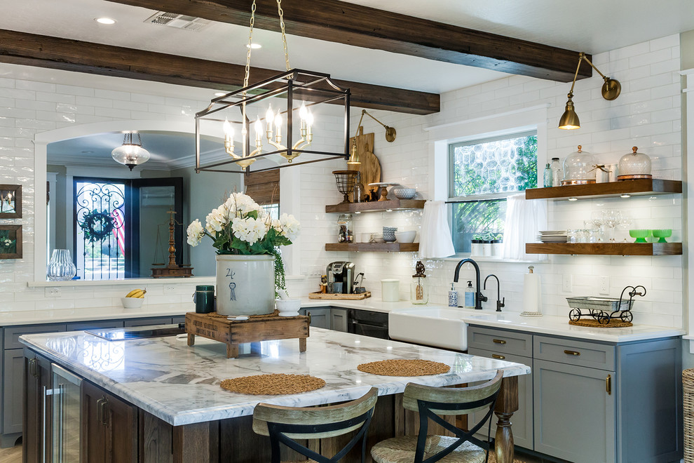 Large transitional l-shaped porcelain tile and brown floor eat-in kitchen photo in Phoenix with a farmhouse sink, shaker cabinets, gray cabinets, quartz countertops, white backsplash, glass sheet backsplash, stainless steel appliances, an island and white countertops