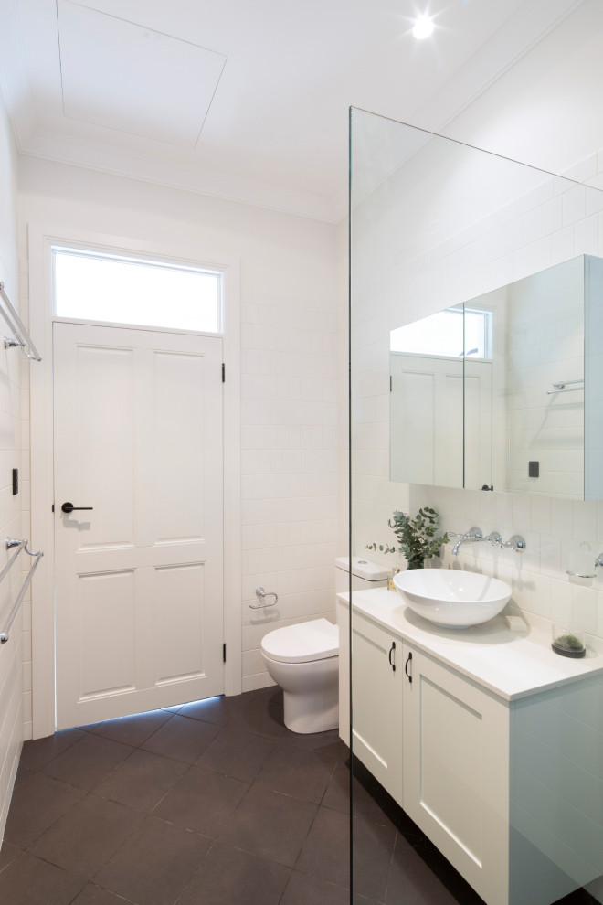 Inspiration for a mid-sized transitional 3/4 bathroom in Sydney with shaker cabinets, white cabinets, a freestanding tub, an open shower, white tile, ceramic tile, white walls, limestone floors, quartzite benchtops, grey floor, an open shower, white benchtops, a two-piece toilet and a vessel sink.