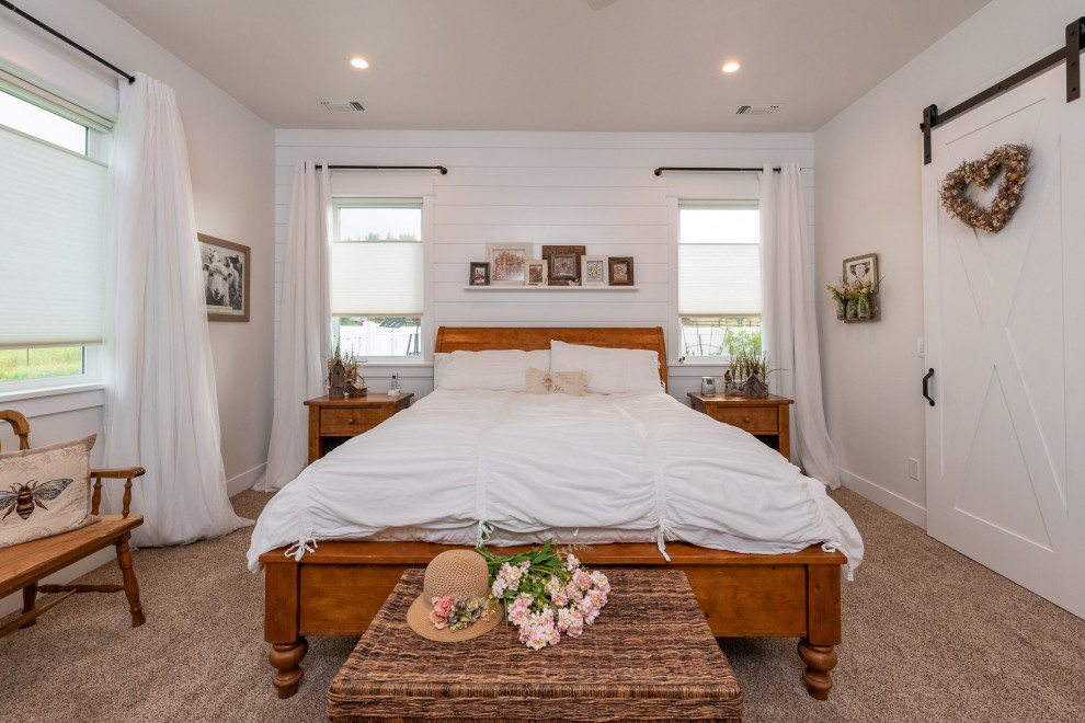 Photo of a mid-sized country master bedroom in Other with white walls, carpet, no fireplace, brown floor and planked wall panelling.