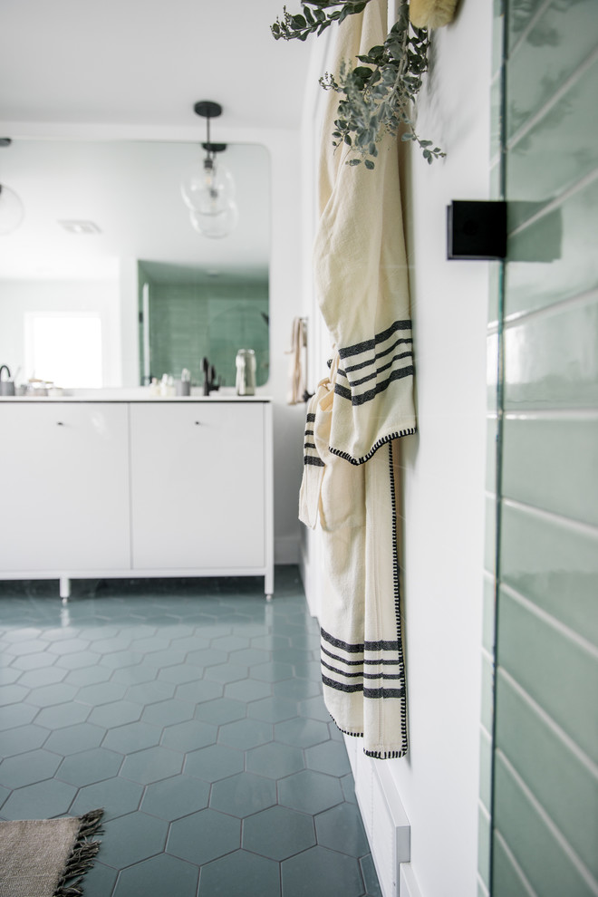 Inspiration for a large scandinavian master bathroom in Grand Rapids with flat-panel cabinets, white cabinets, a freestanding tub, an alcove shower, green tile, ceramic tile, white walls, ceramic floors, an undermount sink, quartzite benchtops, green floor, a hinged shower door and white benchtops.