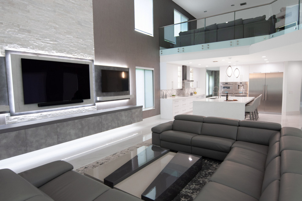 Large modern open concept living room in Miami with grey walls, porcelain floors, white floor and wallpaper.