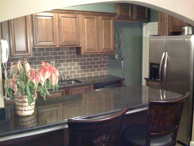 Example of a transitional kitchen design in DC Metro with beaded inset cabinets, dark wood cabinets and granite countertops