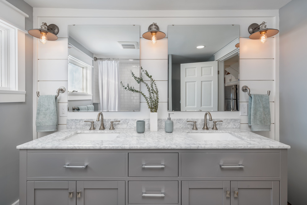 This is an example of a small transitional bathroom in Boston with shaker cabinets, grey cabinets, an alcove tub, an alcove shower, subway tile, grey walls, an undermount sink, marble benchtops, a shower curtain and grey benchtops.