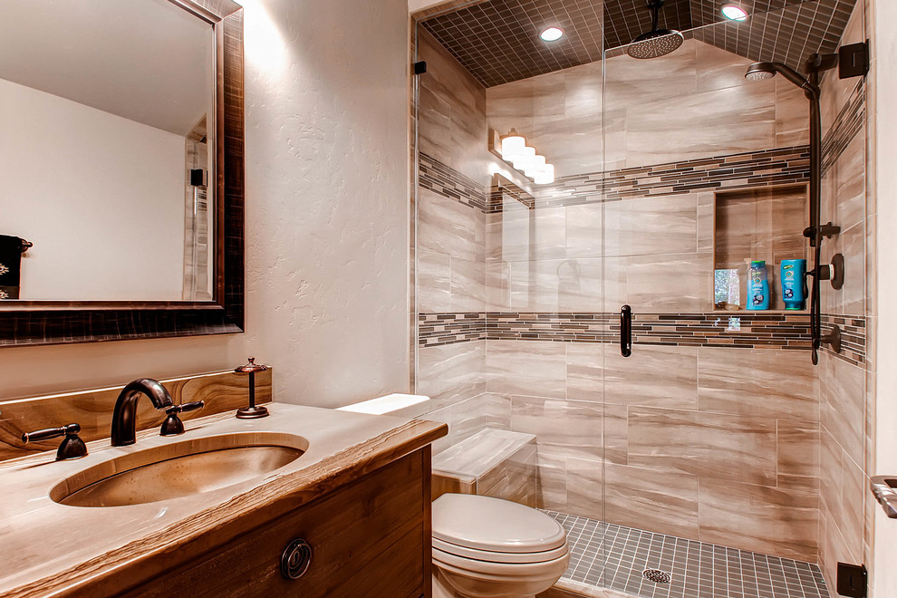 Transitional bathroom in Denver with a freestanding tub and medium wood cabinets.