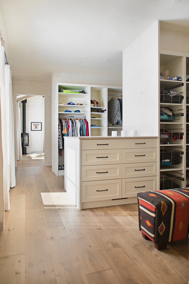 Mountain style light wood floor closet photo with shaker cabinets and white cabinets