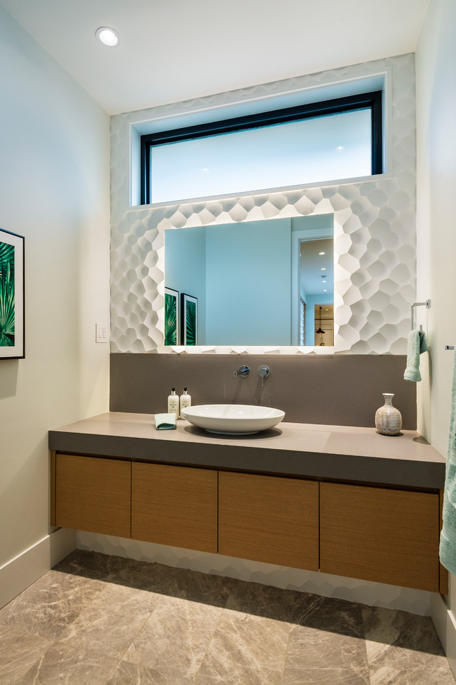 Inspiration for a small contemporary powder room in Vancouver with flat-panel cabinets, medium wood cabinets, white tile, porcelain tile, white walls, porcelain floors, a vessel sink, engineered quartz benchtops, grey benchtops and brown floor.