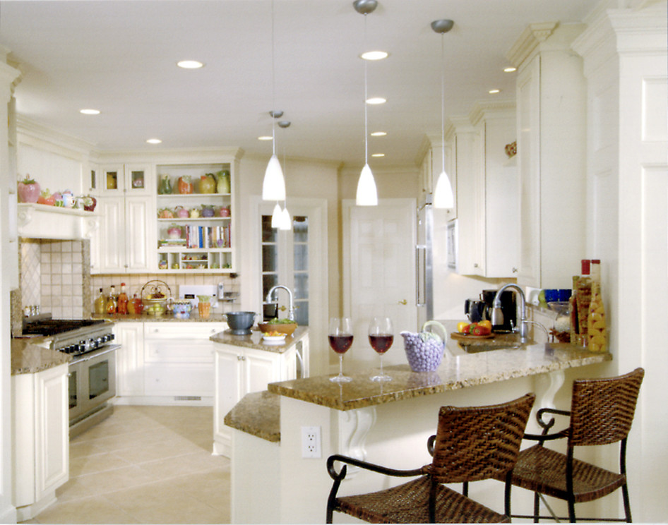 This is an example of a traditional u-shaped open plan kitchen in DC Metro with a single-bowl sink, beaded inset cabinets, white cabinets, granite benchtops, beige splashback, ceramic splashback, stainless steel appliances, ceramic floors and with island.