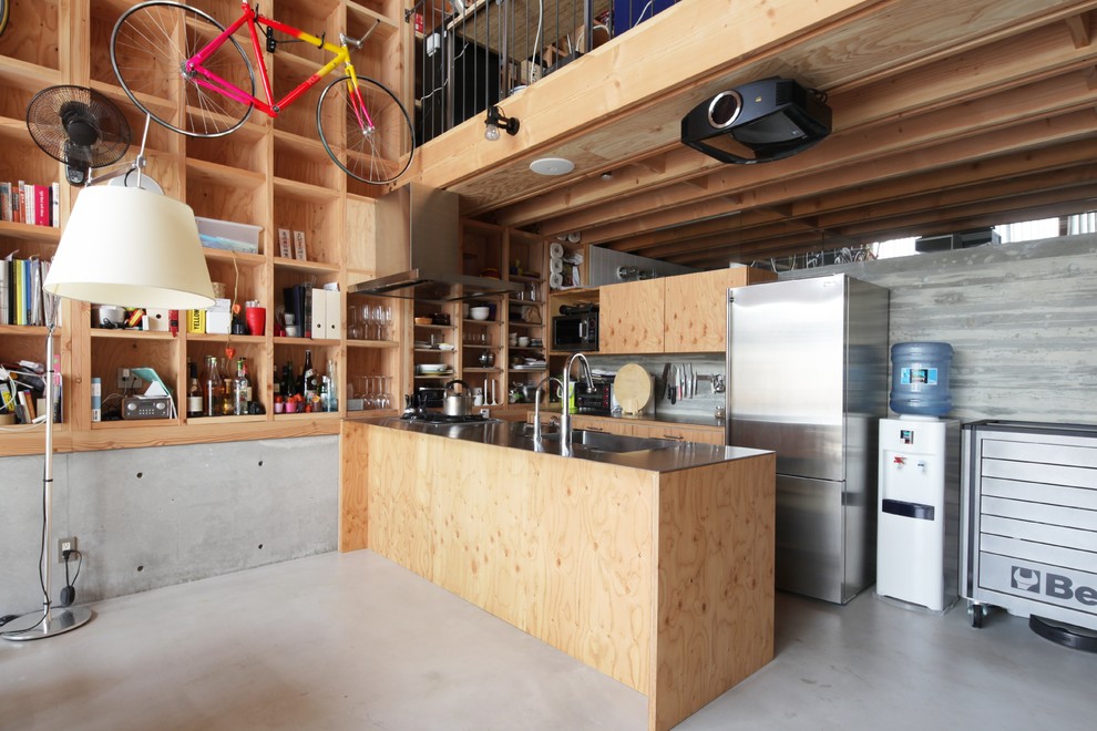 Photo of an industrial u-shaped kitchen in Tokyo Suburbs with an undermount sink, flat-panel cabinets, light wood cabinets, grey splashback, cement tile splashback, stainless steel appliances, concrete floors and a peninsula.