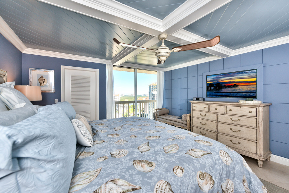 Inspiration for a large beach style master bedroom in Miami with blue walls, porcelain floors and no fireplace.