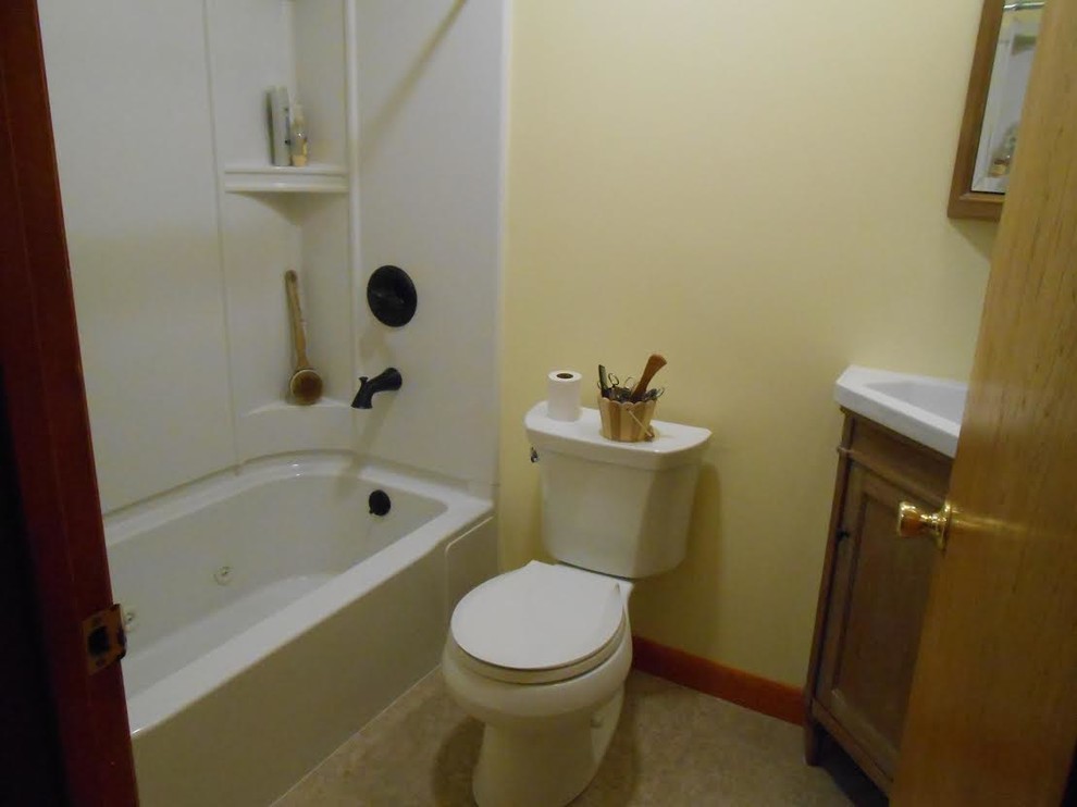 Inspiration for a small transitional kids bathroom in Boston with an integrated sink, medium wood cabinets, an alcove tub, a two-piece toilet, yellow walls, a shower/bathtub combo, marble benchtops, shaker cabinets, beige floor and a shower curtain.
