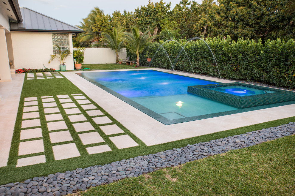 Photo of a large modern backyard rectangular lap pool in Miami.