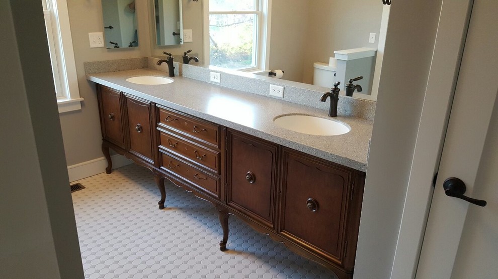 Inspiration for a mid-sized traditional master bathroom in Orange County with recessed-panel cabinets, dark wood cabinets, a two-piece toilet, beige walls, porcelain floors, an undermount sink, laminate benchtops and white floor.
